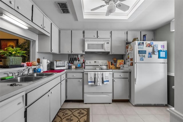 kitchen featuring sink, white appliances, light tile patterned floors, and ceiling fan