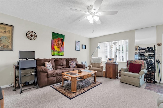 living room featuring ceiling fan and a textured ceiling