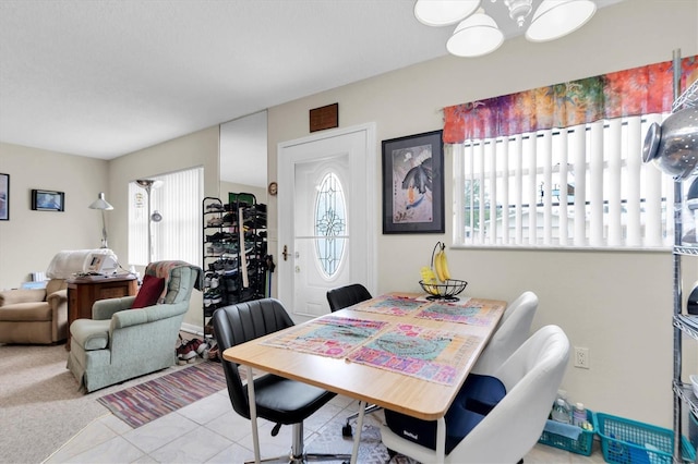 tiled dining area featuring a healthy amount of sunlight