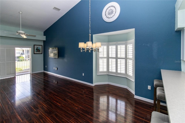 interior space featuring a healthy amount of sunlight, ceiling fan with notable chandelier, and wood-type flooring