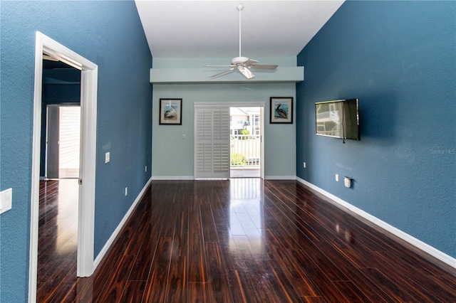 unfurnished room featuring ceiling fan and dark hardwood / wood-style flooring