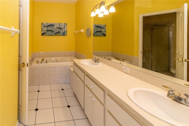 full bathroom with independent shower and bath, tile patterned floors, vanity, and toilet