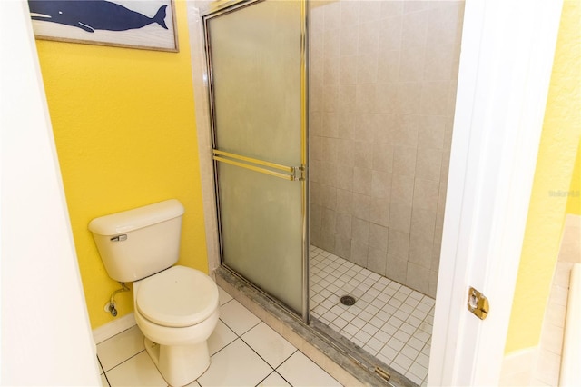 bathroom with toilet, tile patterned floors, and walk in shower