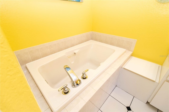 bathroom with tiled bath and tile patterned floors