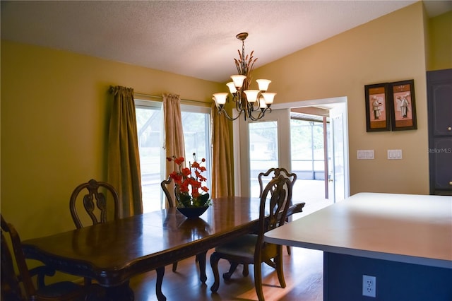 dining room with an inviting chandelier, wood-type flooring, vaulted ceiling, and a textured ceiling