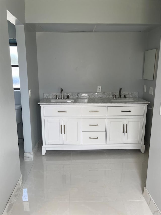 bathroom with vanity, tile patterned flooring, and toilet