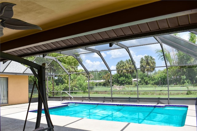 view of swimming pool with a lanai and a patio