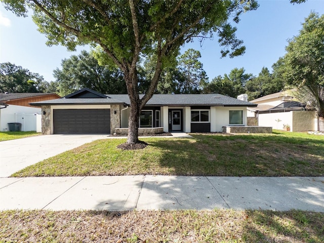 ranch-style home featuring a front yard and a garage