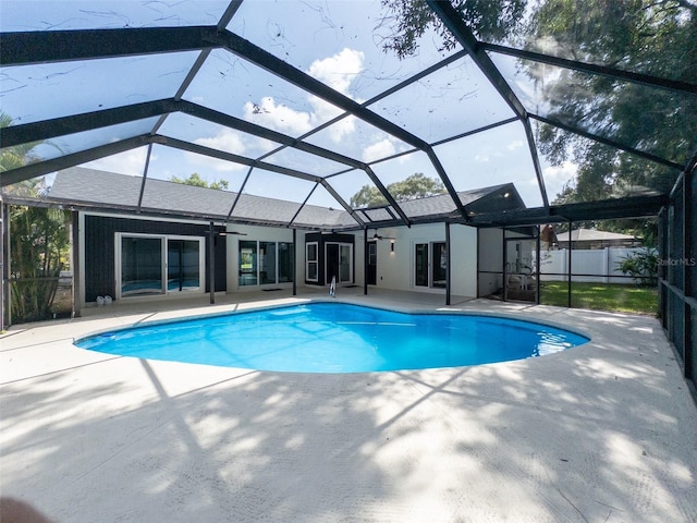 view of swimming pool with a lanai, a patio area, and ceiling fan