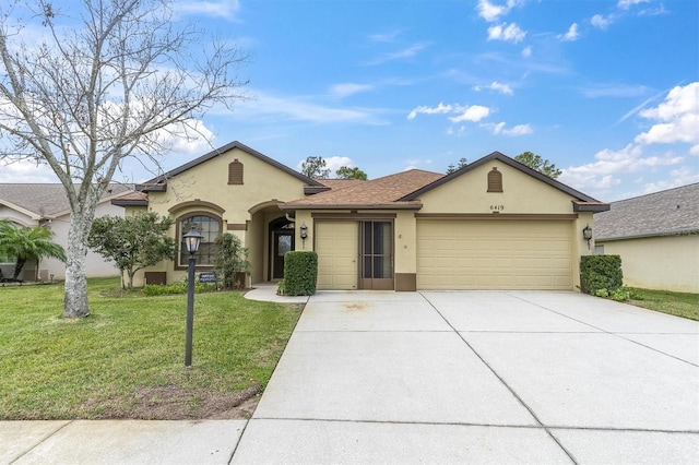 ranch-style home featuring a front lawn and a garage