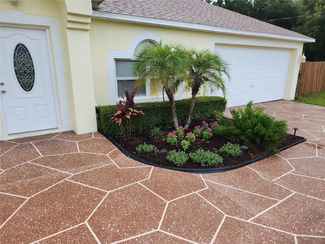 view of exterior entry with a garage