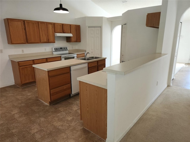 kitchen with pendant lighting, sink, white appliances, dark carpet, and kitchen peninsula