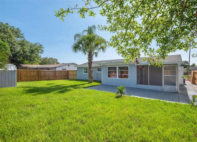 back of property featuring a patio area and a yard