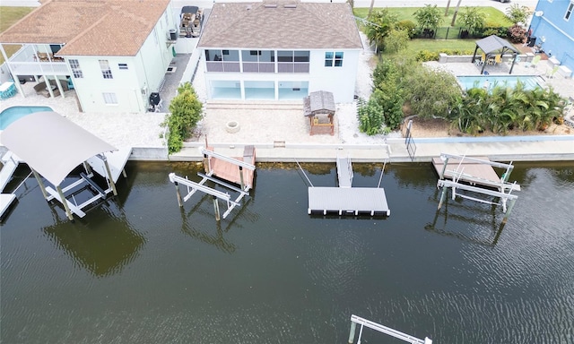 view of dock with a water view and a patio area