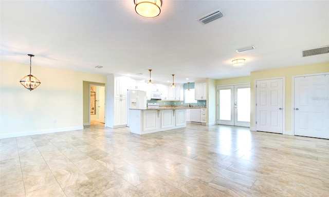 unfurnished living room featuring light tile patterned floors and french doors