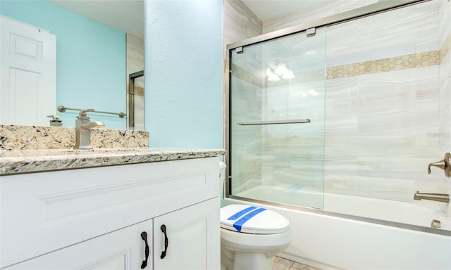 full bathroom with vanity, toilet, bath / shower combo with glass door, and tile patterned flooring