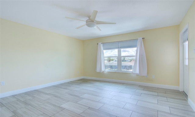 tiled spare room with ceiling fan