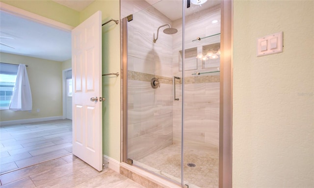 bathroom with tile patterned floors and an enclosed shower