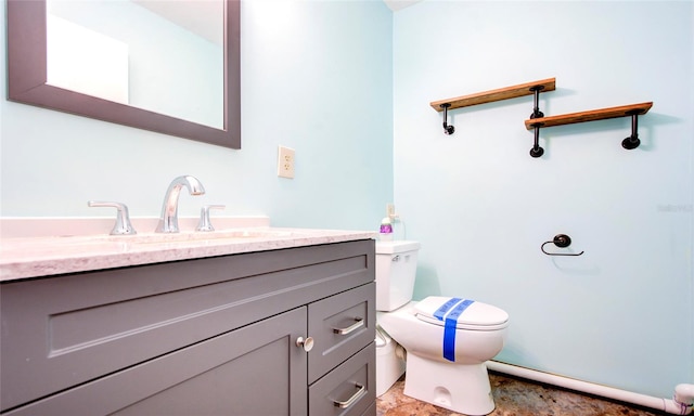 bathroom with tile patterned floors, vanity, and toilet