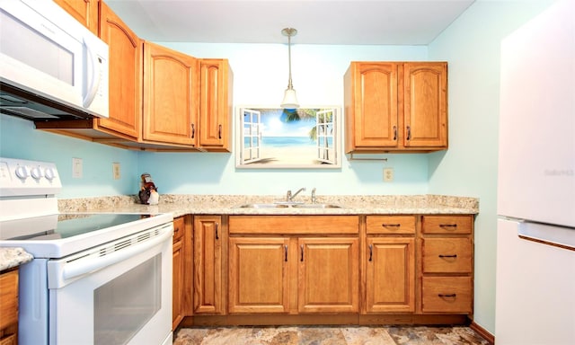 kitchen featuring light tile patterned flooring, sink, white appliances, and decorative light fixtures