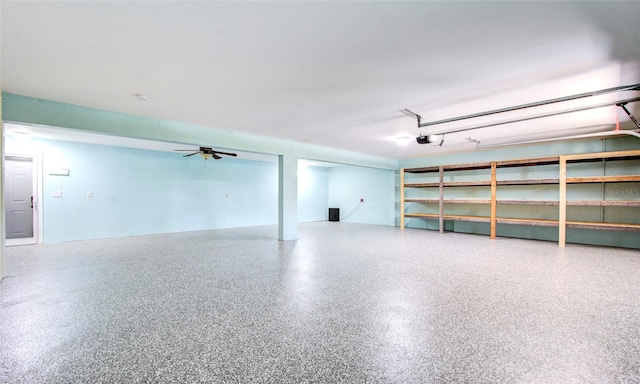 garage with a garage door opener and ceiling fan