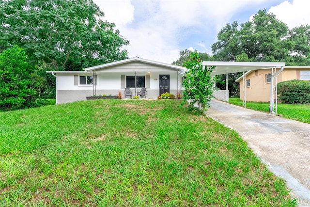 view of front of home with a carport, a porch, and a front lawn