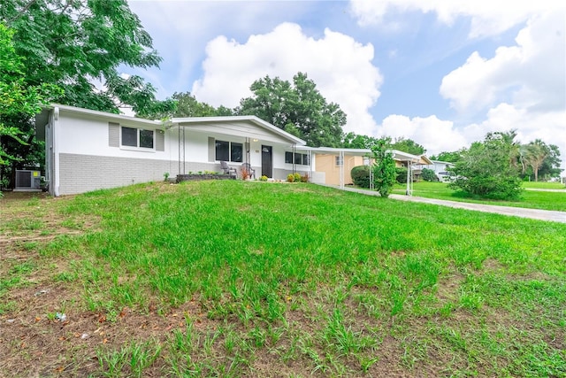 single story home with an attached carport, covered porch, brick siding, concrete driveway, and a front yard