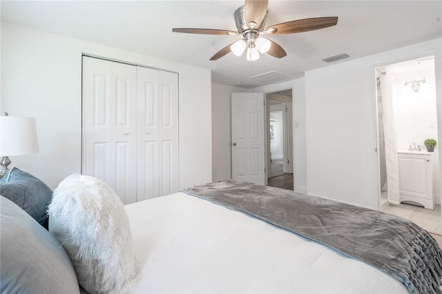 tiled bedroom featuring connected bathroom, a closet, and ceiling fan