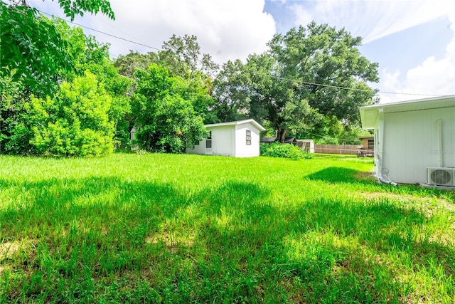 view of yard with ac unit and fence