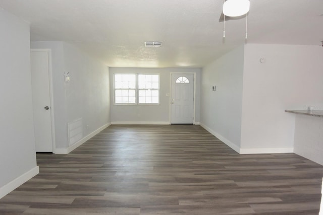 unfurnished living room featuring dark hardwood / wood-style floors