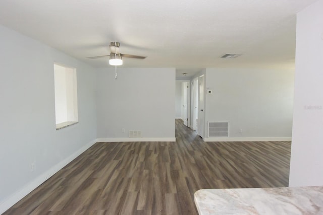 empty room with ceiling fan and dark hardwood / wood-style floors