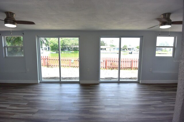 interior space featuring ceiling fan, a healthy amount of sunlight, and hardwood / wood-style flooring