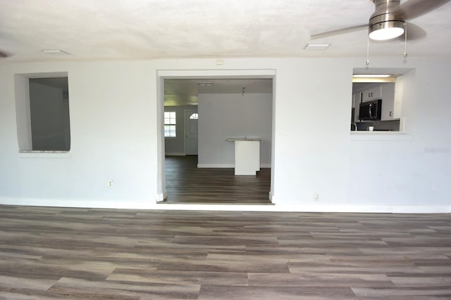 empty room with ceiling fan and wood-type flooring