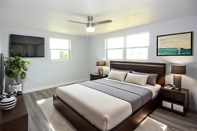 bedroom with ceiling fan and wood-type flooring