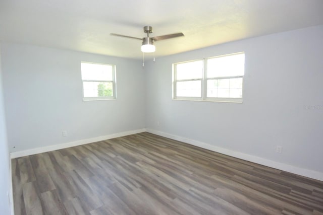 empty room featuring ceiling fan and dark hardwood / wood-style flooring