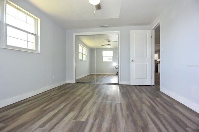 empty room featuring ceiling fan and dark wood-type flooring