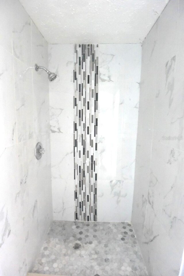 bathroom with a tile shower