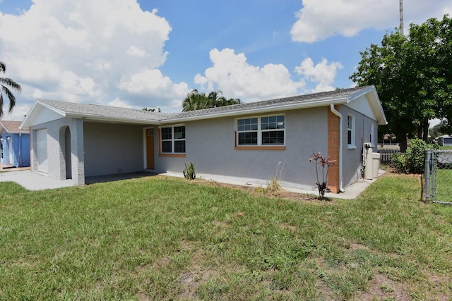 rear view of house featuring a lawn