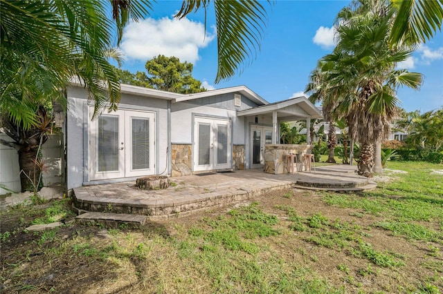 rear view of house featuring french doors and a patio area