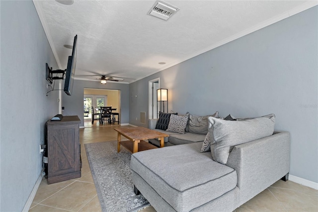 tiled living room with a textured ceiling, ceiling fan, and crown molding