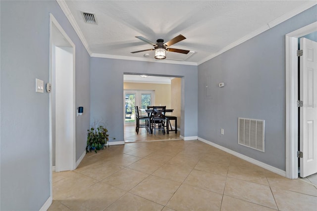 interior space with a textured ceiling, ornamental molding, light tile patterned floors, and ceiling fan