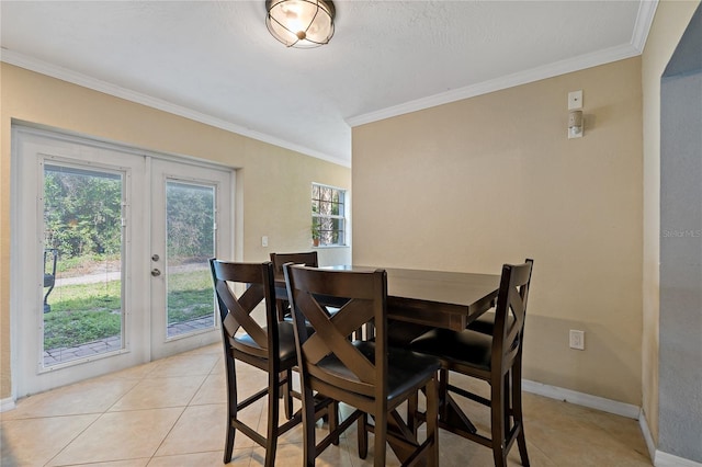 tiled dining space with ornamental molding and french doors