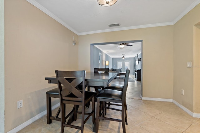 dining area with ornamental molding, light tile patterned floors, and ceiling fan