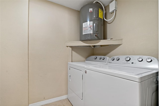 washroom with electric water heater, light tile patterned floors, and independent washer and dryer