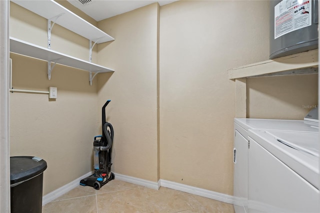 laundry room featuring washing machine and dryer and light tile patterned floors