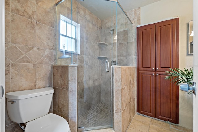 bathroom with a shower with door, tile patterned flooring, toilet, and tile walls