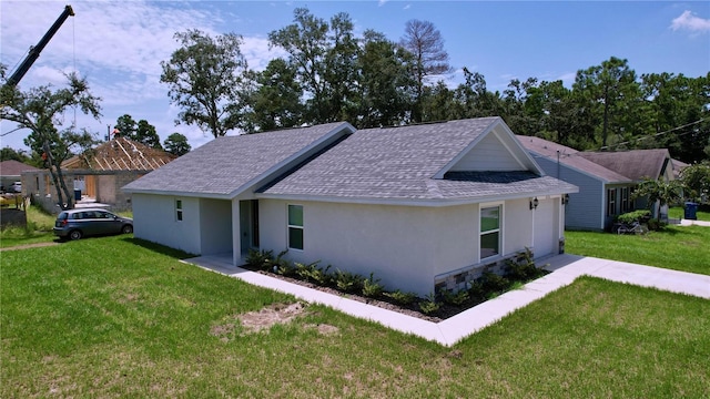 view of side of home with a lawn