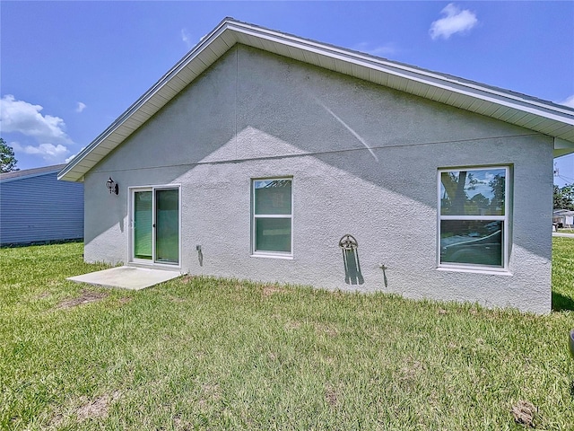 rear view of house featuring a yard