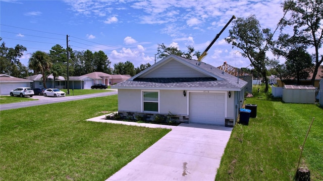 ranch-style house featuring a garage and a front lawn