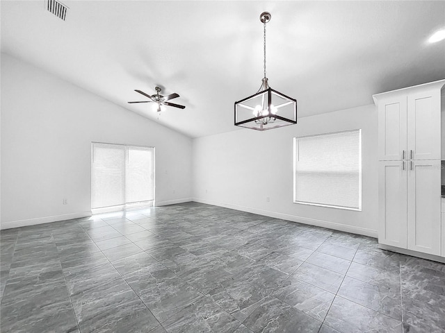 tiled empty room with lofted ceiling and ceiling fan with notable chandelier